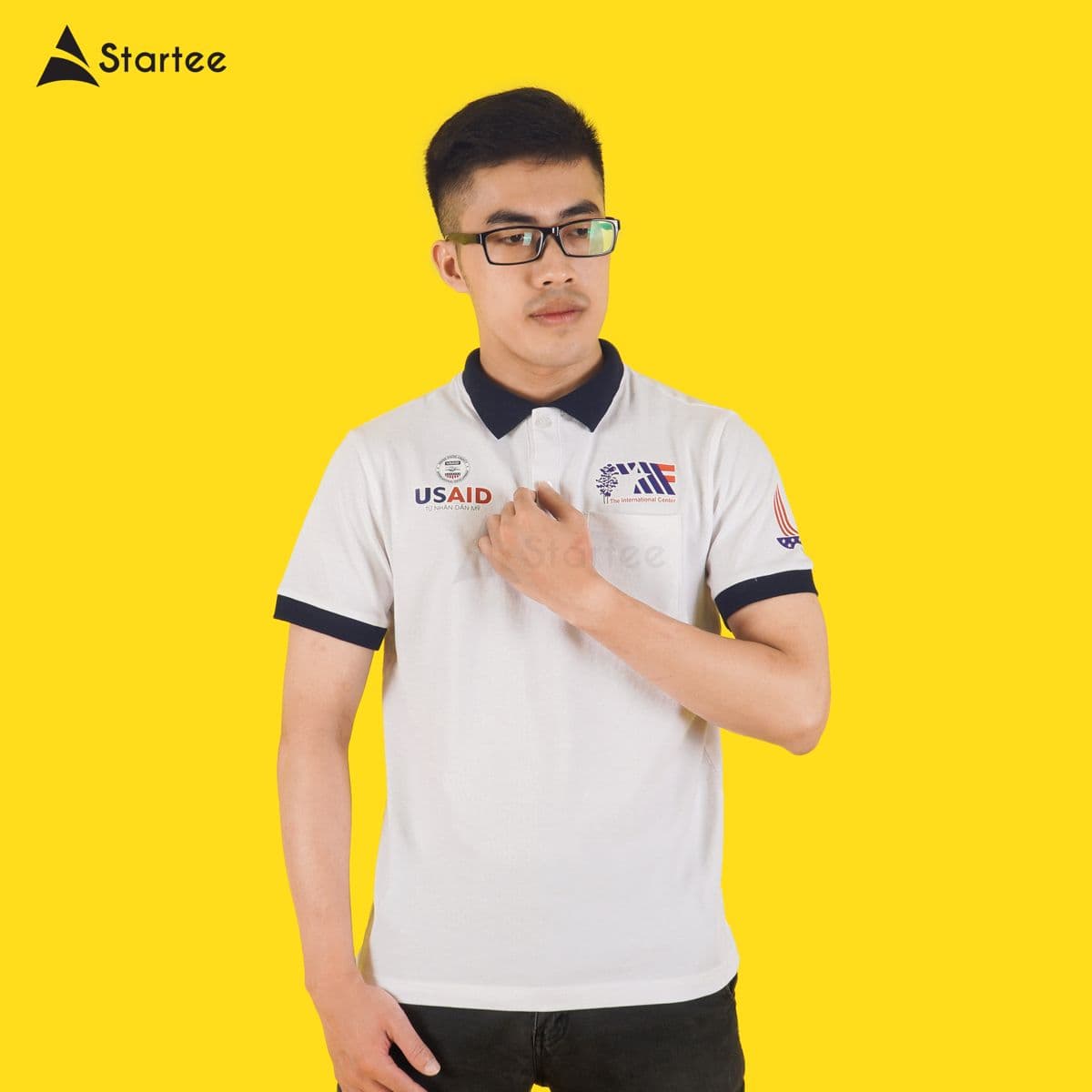 White polo with a navy collar for the International Center, made by Startee